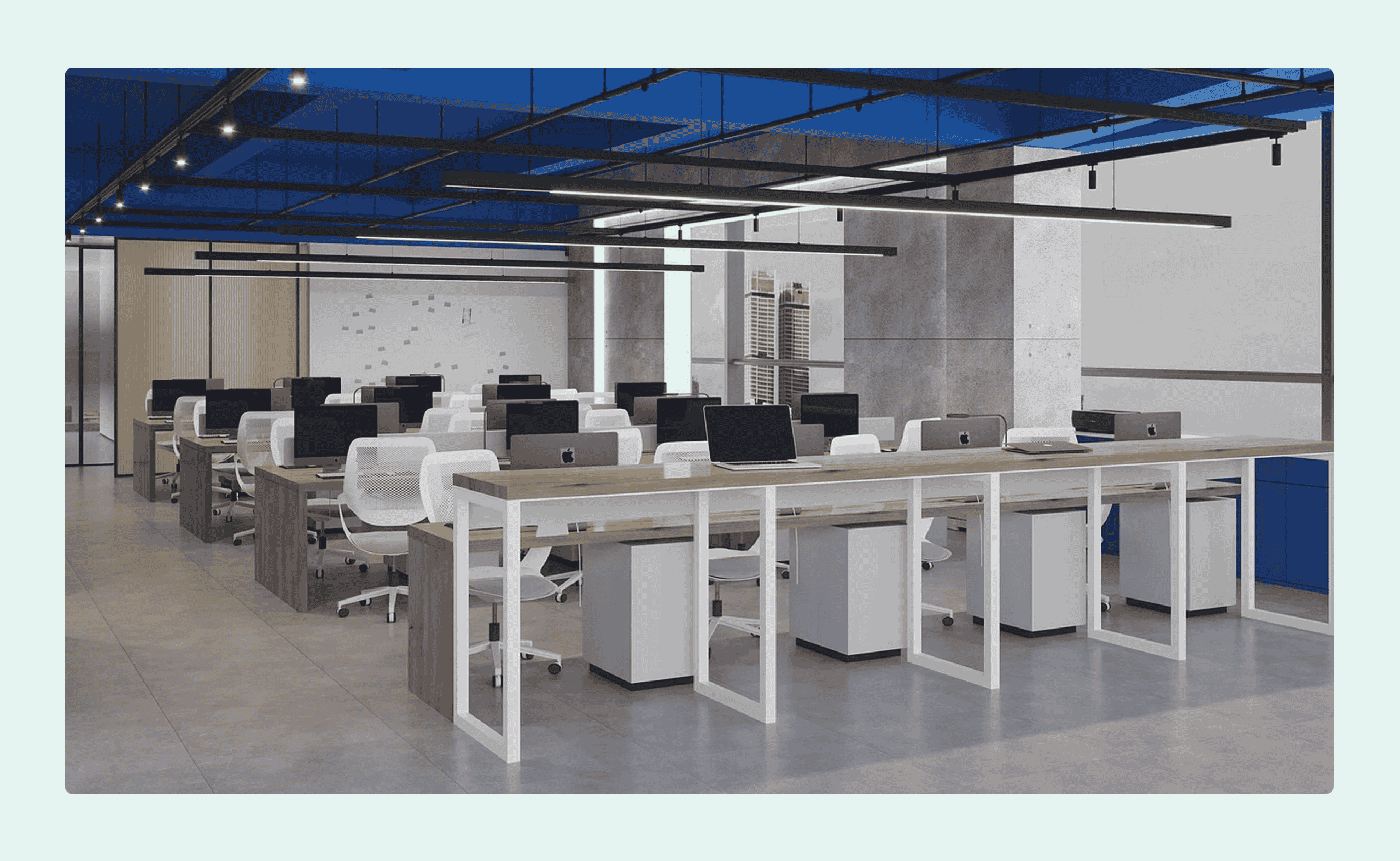 Modern open-plan office with rows of desks, white chairs, and desktop computers under a blue ceiling.